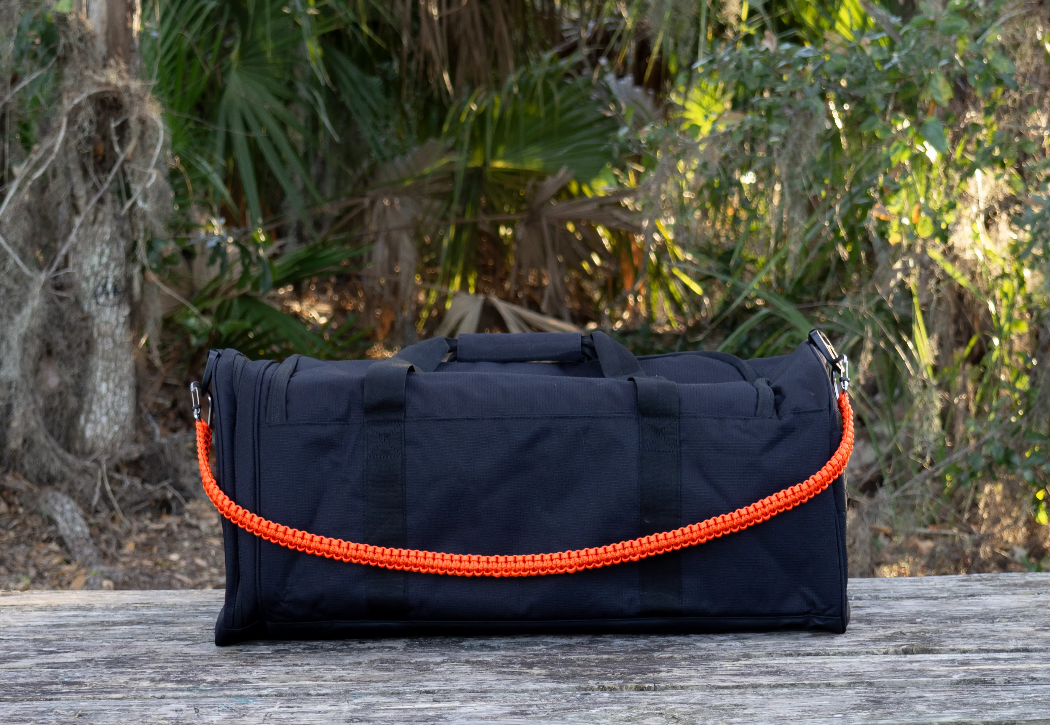 Gray THIRSTLOCK™ custom paracord build shown as a keychain with bottle opener carabiner.